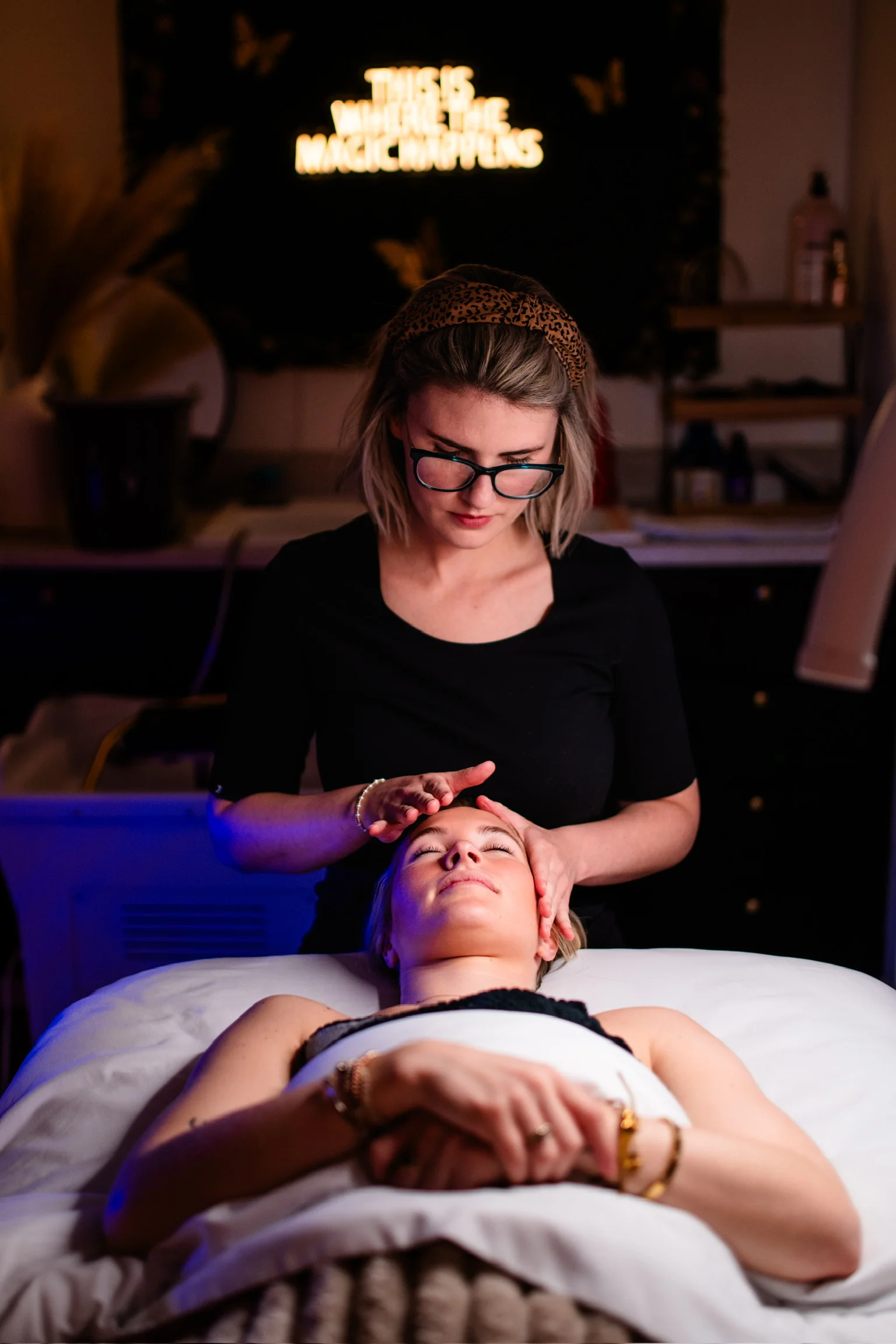 Client receiving a HydraFacial treatment at Paradigm Salon & Spa