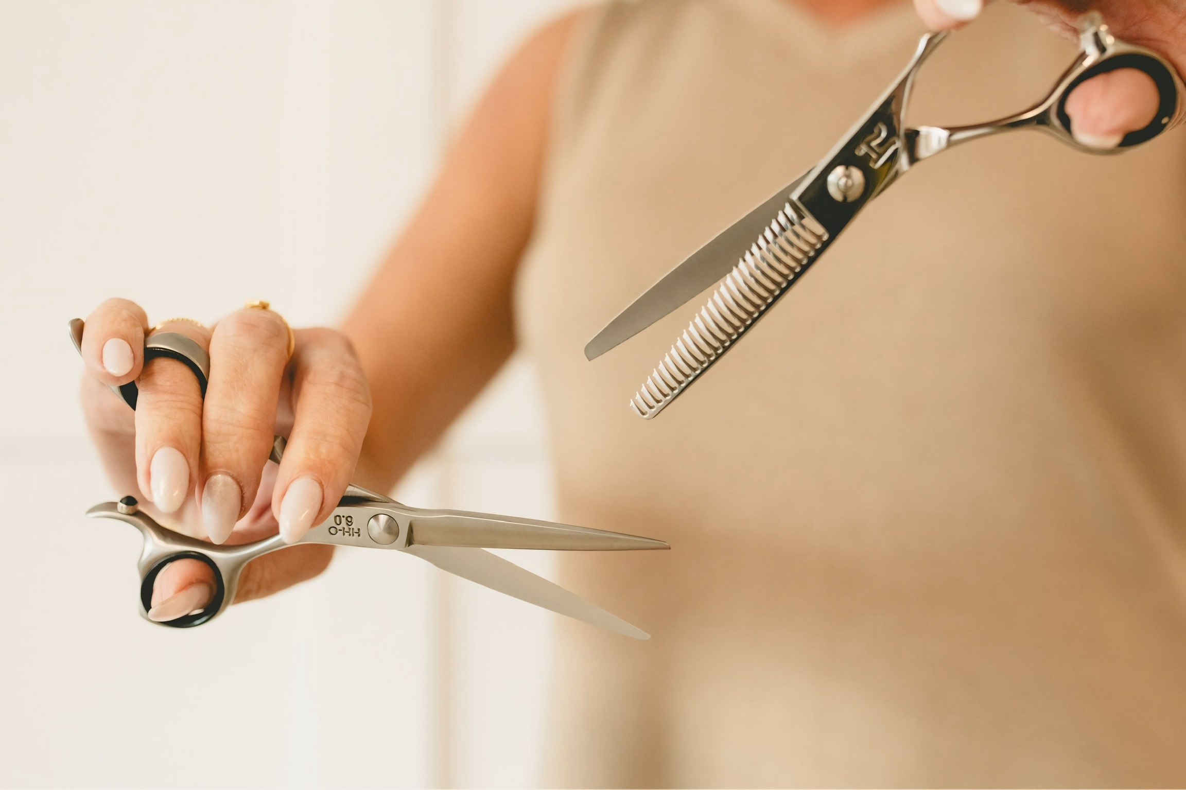 Stylist holding shears at Paradigm Salon & Spa