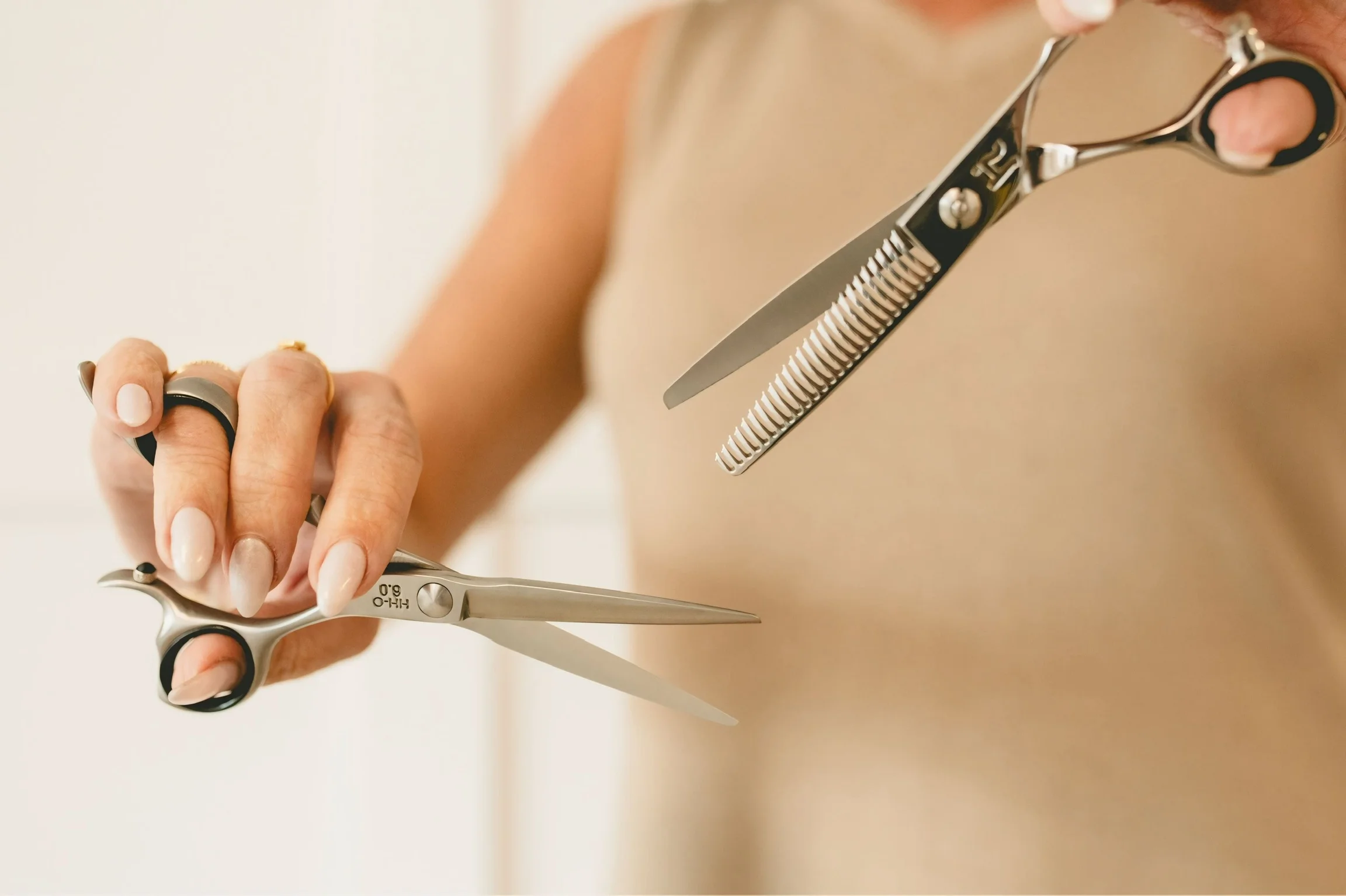 Stylist holding shears at Paradigm Salon & Spa