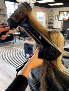 girl getting hair blow dried after hair cut